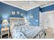 Comfortable bedroom with blue walls, coastal decor, white furniture, and a ceiling fan at 6253 Catalina Dr. # 1824, North Myrtle Beach, SC 29582