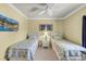 Bedroom with two twin beds, yellow walls, white furniture, and a ceiling fan at 6253 Catalina Dr. # 1824, North Myrtle Beach, SC 29582