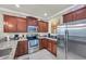 Fully-equipped kitchen featuring stainless steel appliances and dark wood cabinets at 6253 Catalina Dr. # 1824, North Myrtle Beach, SC 29582