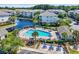 Aerial view of community pool with lounge chairs and palm trees next to the lake at 6253 Catalina Dr. # 1824, North Myrtle Beach, SC 29582