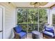 Comfortable screened-in porch features seating and scenic views of trees at 6253 Catalina Dr. # 1824, North Myrtle Beach, SC 29582