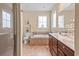 Bright bathroom featuring a garden tub, double sink vanity, and separate shower at 668 Barona Dr., Myrtle Beach, SC 29579