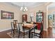 Cozy dining room featuring a wooden table, six chairs, and display cases for storage and decor at 668 Barona Dr., Myrtle Beach, SC 29579