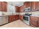 Kitchen featuring granite countertops, stainless steel appliances, and rich wood cabinetry at 668 Barona Dr., Myrtle Beach, SC 29579