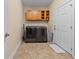 Well-organized laundry room featuring wood cabinets and modern washer and dryer at 668 Barona Dr., Myrtle Beach, SC 29579