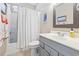 Cozy bathroom with shower/tub combo, white shower curtain, and gray vanity at 670 2Nd Ave. N, North Myrtle Beach, SC 29582