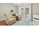 Comfortable sitting area with french doors, hardwood floors, and neutral decor at 670 2Nd Ave. N, North Myrtle Beach, SC 29582