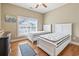 Bedroom showcasing two twin beds, hardwood floors, and natural light at 670 2Nd Ave. N, North Myrtle Beach, SC 29582