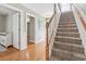 Inviting entryway featuring a carpeted staircase, wood floors, and wainscoting at 670 2Nd Ave. N, North Myrtle Beach, SC 29582
