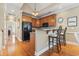 Compact kitchen with wood cabinets, breakfast bar, and hardwood floors at 670 2Nd Ave. N, North Myrtle Beach, SC 29582