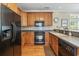 Kitchen featuring stainless steel appliances, wood cabinetry, and tile backsplash at 670 2Nd Ave. N, North Myrtle Beach, SC 29582