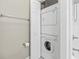 Bathroom featuring a stacked washer and dryer and a full-length mirror at 670 2Nd Ave. N, North Myrtle Beach, SC 29582