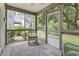 Relaxing screened porch with neutral color scheme, a ceiling fan, and views of the backyard at 670 2Nd Ave. N, North Myrtle Beach, SC 29582