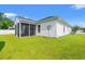 The backyard features a screened in porch and green lawn with trees at 708 Alexis Dr., Longs, SC 29568