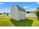 Spacious backyard featuring a storage shed, a white picket fence, and well-manicured green grass at 708 Alexis Dr., Longs, SC 29568