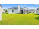 Backyard with a bright green lawn and a screened in porch at 708 Alexis Dr., Longs, SC 29568