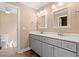 Bathroom featuring a double sink vanity with grey cabinets, framed mirrors, and modern fixtures at 708 Alexis Dr., Longs, SC 29568