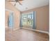 Bright bedroom with wood-look floors, neutral walls, ceiling fan, and large window with front yard view at 708 Alexis Dr., Longs, SC 29568