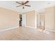 Bright bedroom features a ceiling fan, wood-look floors, and access to the kitchen and bathroom at 708 Alexis Dr., Longs, SC 29568
