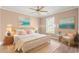 Staged bedroom with a rattan bed frame, wicker furniture, and beach-themed artwork at 708 Alexis Dr., Longs, SC 29568