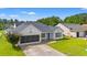 Charming one-story home with blue accents, a screened garage, and a well-manicured lawn at 708 Alexis Dr., Longs, SC 29568