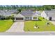 Inviting one-story home with a manicured lawn, a screened garage, and colorful landscaping at 708 Alexis Dr., Longs, SC 29568
