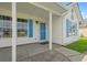 Charming home featuring a covered front porch, a bright blue front door and matching shutters at 708 Alexis Dr., Longs, SC 29568
