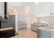 Well-lit kitchen boasts granite countertops, stainless steel appliances, and modern pendant lighting at 708 Alexis Dr., Longs, SC 29568