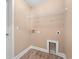Clean, unfinished laundry room with vinyl flooring and connection hookups for washer and dryer at 708 Alexis Dr., Longs, SC 29568