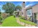 View of backyard with stone path, covered patio, and manicured lawn at 709 Jerdon Circle, North Myrtle Beach, SC 29582