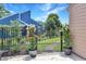 View of backyard with lush green lawn, flowers, and an iron fence surrounding the yard at 709 Jerdon Circle, North Myrtle Beach, SC 29582