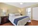 Bedroom with ensuite bathroom, hardwood floors, and a large bright window at 709 Jerdon Circle, North Myrtle Beach, SC 29582