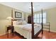 Bedroom featuring a four-poster bed, hardwood floors, and plantation shutters at 709 Jerdon Circle, North Myrtle Beach, SC 29582