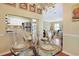 Charming dining area with a glass-topped table, set for four, adjacent to an open kitchen at 709 Jerdon Circle, North Myrtle Beach, SC 29582