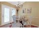 Elegant dining room with decorative chandelier, glass table set for four, and door to outside at 709 Jerdon Circle, North Myrtle Beach, SC 29582