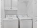 Bright laundry room with white appliances and built-in storage shelves at 709 Jerdon Circle, North Myrtle Beach, SC 29582