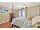 Well-lit bedroom features a four-poster bed, hardwood floors, and sliding glass doors to a patio at 709 Jerdon Circle, North Myrtle Beach, SC 29582