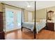 Bright bedroom with a four-poster bed, hardwood floors, and private access to the patio at 709 Jerdon Circle, North Myrtle Beach, SC 29582
