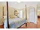 Inviting bedroom featuring a four-poster bed, hardwood floors, and ample natural light at 709 Jerdon Circle, North Myrtle Beach, SC 29582