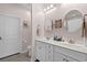 Bright bathroom featuring double sink vanity, white cabinetry, framed art, and neutral walls and floors at 754 Salerno Circle # F, Myrtle Beach, SC 29579