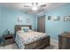 Cozy bedroom with blue walls, wood furniture, and a ceiling fan, creating a relaxing space at 754 Salerno Circle # F, Myrtle Beach, SC 29579