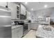 Well-lit kitchen features stainless steel appliances, granite countertops, and tiled flooring and backsplash at 754 Salerno Circle # F, Myrtle Beach, SC 29579