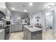 Modern kitchen with stainless appliances, stone countertops, island, and ample lighting at 754 Salerno Circle # F, Myrtle Beach, SC 29579