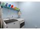 Bright laundry area featuring modern appliances, shelving for storage, and clean, light-colored walls at 754 Salerno Circle # F, Myrtle Beach, SC 29579