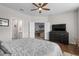 Main bedroom with hardwood floors featuring a large bed and ensuite bathroom and open access to the living area at 754 Salerno Circle # F, Myrtle Beach, SC 29579