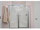 Enclosed shower featuring a glass door with steel frame and neutral walls with an adjacent white door at 754 Salerno Circle # F, Myrtle Beach, SC 29579