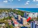 Beautiful aerial shot of Ocean View Tower, nestled among trees, near the beach and other residential properties at 7601 N Ocean Blvd. # 3-B, Myrtle Beach, SC 29572
