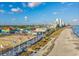Aerial view of a beach boardwalk featuring an amusement park with a large Ferris wheel and beachfront at 7601 N Ocean Blvd. # 3-B, Myrtle Beach, SC 29572