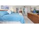 Bedroom featuring a blue bedspread, wood dresser, and neutral carpet at 7601 N Ocean Blvd. # 3-B, Myrtle Beach, SC 29572