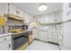 Well-lit kitchen featuring bright cabinets, essential appliances, and tile flooring, offering a practical cooking space at 7601 N Ocean Blvd. # 3-B, Myrtle Beach, SC 29572